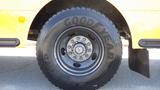 Close-up of a Goodyear tire mounted on a black rim from a 2014 Freightliner Thomas Diesel bus