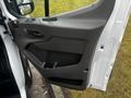 The door panel of a 2020 Ford Transit showing the handle and storage compartment