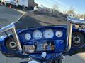 Close-up of the dashboard and controls of a 2017 Harley-Davidson FLHXS featuring gauges a touchscreen display and speakers