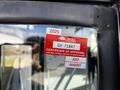 A red and white certification sticker on a vehicle featuring the words Certificate of Approval and expired dates for July and August 2025