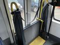 A yellow and black wheelchair lift mechanism mounted inside a vehicle designed for accessibility