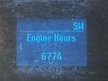Display screen showing engine hours with the value 6774 on a blue background