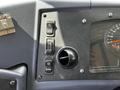 Dashboard controls of a 2022 Blue Bird BB Conventional bus featuring switches and a gauge for speed and engine functions