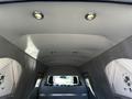Interior view of a 2013 Lincoln MKT with a spacious ceiling featuring recessed lights and a plush, soft gray finish