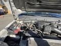 Close-up of the engine compartment of a 2014 Ford F-350 SD showcasing various components including the battery and engine parts