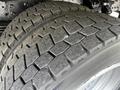 Close-up of two heavy-duty tires from a 2018 Hino 195 showing tread patterns and rubber surface details