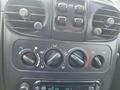 Dashboard controls of a 2005 Chrysler PT Cruiser featuring air conditioning knobs and a radio display
