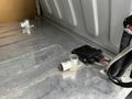 Interior view of a 2016 Ford Transit Connect showcasing a metal floor with two metal fittings and an electrical component mounted on the surface