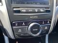 Dashboard console of a 2017 Acura TLX featuring buttons for navigation phone info audio and a central control dial