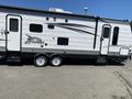 A 2016 Jayco 265RLSW travel trailer with a white exterior featuring gray and black detailing and dual axles