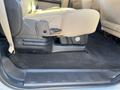 Interior view of a 2014 Ford F-350 SD showcasing the driver's side seat with beige upholstery and a black floor mat in the foreground