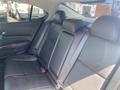 Interior of a 2017 Acura TLX showing the back seat with black leather upholstery and seat belts attached