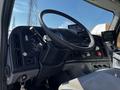 The interior of a 2012 Freightliner M2 112 featuring a steering wheel dashboard controls and various gauges