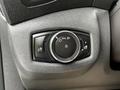 Control panel for headlights on a 2014 Ford Transit Connect featuring a round dial with symbols for light settings