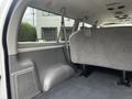Interior view of a 2008 Ford Econoline showing the rear seating area with gray upholstery and minimal furnishings