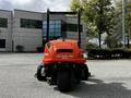 A 2015 Jacobsen Eclipse 322 lawn mower with a bright orange body and a tall handle visible at the back