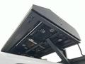 A black equipment rack mounted on the roof of a 2015 Ford F-550 featuring multiple circular LED lights and a mechanical component underneath