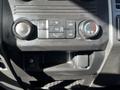 Dashboard controls of a 2018 Ford F-550 featuring climate control knobs and an A/C button