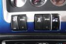 Control panel with various buttons labeled Start Stop Spare and icons for truck functions on a 2015 Kenworth T660