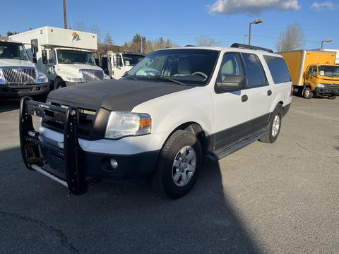 A white 2013 Ford Expedition with a black front grille guard and black running boards parked in a lot