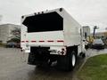 A white 2007 Freightliner M2 106 vehicle with a boxy cargo area and taillights visible at the rear