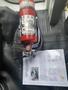 A 2018 Chevrolet Express with a fire extinguisher placed on the floor alongside a document detailing its specifications and instructions