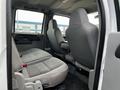 Interior of a 2007 Ford F-550 showing two front seats and two back seats upholstered in gray fabric with a simple layout