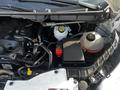 A 2017 Ford Transit engine compartment showing various components including a battery coolant reservoir and multiple hoses and wires