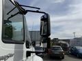 A 2011 International 4300 truck with a close-up view of its side mirror and part of the truck's body visible
