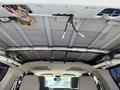 Interior view of a 2013 Ford Expedition showing exposed wiring and a disassembled overhead lining