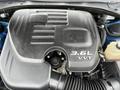 Engine compartment of a 2022 Dodge Charger featuring a black engine cover with a 3.6L VVT label and visible air intake components