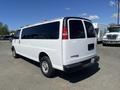 A white 2012 Chevrolet Express van viewed from the rear with tinted windows and a simple design featuring a rear bumper and no visible markings