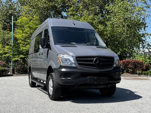 A 2017 Mercedes-Benz Sprinter van in a gray color with a front view showcasing the grille and headlights