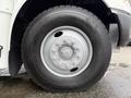 A close-up of a silver wheel with a tire marked with the Michelin logo and various bolts visible on the hub of a 2016 International CE300 vehicle