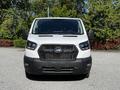 White 2023 Ford Transit van with a black front grille and headlights facing forward