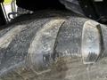 Close-up of a rugged tire from a 2020 Pottinger Impress showing deep treads and wear marks