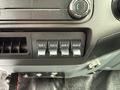 Close-up of the control panel in a 2015 Ford F-350 SD featuring four auxiliary switches labeled AUX 1 to AUX 4 and various climate control knobs