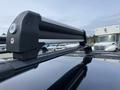 Close-up of a roof rack on a 2015 Kia Sorento highlighting the crossbars and mounting hardware