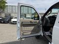 A 2008 Ford F-550 with the driver's side door open revealing beige interior features including a control panel and door handle