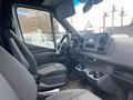 Interior view of a 2024 Mercedes-Benz Sprinter showing the driver's seat dashboard and control panel