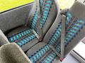 Interior seats of a 2022 Blue Bird BB Conventional bus featuring fabric with a blue and gray pattern and seatbelts