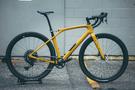 A 2024 Specialized Turbo Levo SL Comp Carbon bicycle in yellow with a sleek frame and wide tires designed for performance and versatility