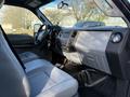 Interior view of a 2012 Ford F-350 featuring grey leather seats and dashboard with controls and trim labeled Super Duty