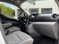 Interior view of a 2020 Nissan NV200 showing the driver's seat steering wheel and dashboard features