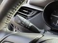 Close-up of the steering wheel control lever for headlight settings in a 2021 Toyota C-HR