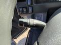 Close-up of the turn signal and headlight control lever inside a 2013 Isuzu NPR vehicle