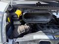 Close-up of the engine compartment of a 2021 RAM Promaster showing the air intake system and various components including a yellow cap and hoses