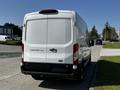 A white 2022 Ford Transit van is parked showing its rear view with a sliding door and taillights visible