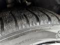 Close-up of a worn tire from a 2019 Ford Transit Connect showing tread patterns and surface wear
