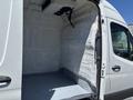 A 2019 Mercedes-Benz Sprinter van with an empty cargo space featuring a smooth, gray floor and white, textured walls